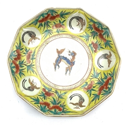 Japanese 18th century decagonal dish in Kakiemon style, Edo, painted with a border pattern of flowers and birds on a yellow ground, the centre with a mythical animal W30cm