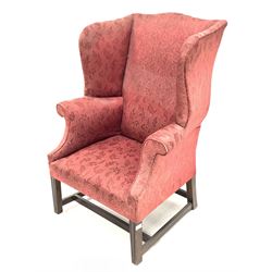 Georgian style high wing back armchair upholstered in claret red floral fabric, raised on moulded square tapered supports W81cm