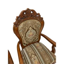 Set ten French style cherry wood dining elbow chairs, pierced pediments decorated with flower heads and c-scrolls, upholstered in floral pattern fabric, cabriole supports carved with flower heads