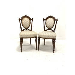 Pair of Victorian walnut upholstered hall chairs, floral carved cresting rail and fluted back supports, raised on turned and fluted front supports, W45cm