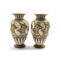  Pair of Doulton Lambeth vases with relief moulded and painted scrolling leaf and flower head decoration on a buff coloured ground with impressed marks to base, no. 445 H24cm   