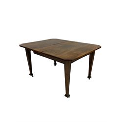  20th century wind-out oak dining table, the rectangular top with rounded corners, raised on square tapering supports, terminating in plastic castors, together with set four oak chairs, upholstered in red leather 
