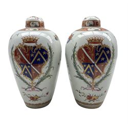 Pair of 19th century Samson of Paris armorial baluster vases and covers decorated in the Chinese manner with a coat of arms, floral sprays etc and with domed covers H26cm