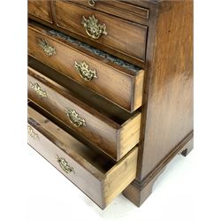 George III mahogany bachelors chest, cross banded top and fitted with brushing slide above two short and three long drawers, raised on bracket supports W85cm, H84cm, D46cm