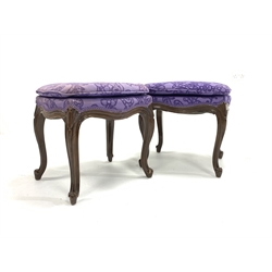  Pair of continental walnut upholstered dressing table stools, raised on scroll carved cabriole supports, W47cm  