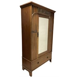 Arts and Crafts oak single wardrobe, the projecting cornice over copper frieze depicting ships sailing and one mirrored door, enclosing interior fitted for hanging, over one drawer, raised on square supports  