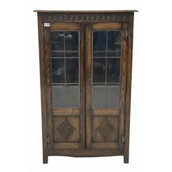 Early 20th century oak bookcase, lunette carved frieze over two lead glazed doors with lozenge carved panels enclosing three shelves, raised on stile supports W75cm