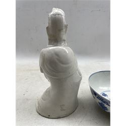 18th century Chinese blanc de chine figure of Kuan Yin, seated, H23cm and an 18th century Chinese bowl decorated with blue lotus scrolls and with character mark to base (a/f) 