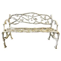 Late 19th to early 20th century cast iron faux bois garden bench, decorated with trailing foliage branches, in white paint finish