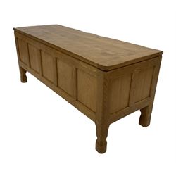 Gott of Pickering - Yorkshire oak style blanket box, the adzed top over four panel front, raised on faceted octagonal supports W107cm, H46cm, D46cm
