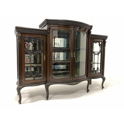 Early 20th century mahogany display cabinet, the central bowed section with bevelled glazed double doors enclosing two shelves, flanked by two further glazed cupboards, raised on cabriole supports 