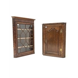 George III oak and mahogany corner cupboard, with astragal glazed door enclosing three shelves, (W78cm) together with another Georgian oak corner cupboard (W69)