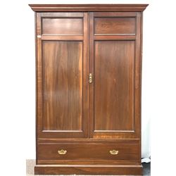 Late 19th/ Early 20th century mahogany wardrobe, moulded cornice over two panelled doors, drawer to base W140cm, H202cm, D57cm
