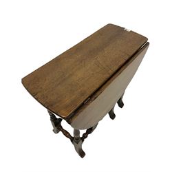 Oak gate leg table, the oval top over gate leg action, raised on turned and block supports 