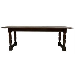 Oak dining table, the rectangular top raised on turned and block supports united by stretcher 