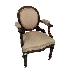 Victorian upholstered armchair, raised on brass castors 