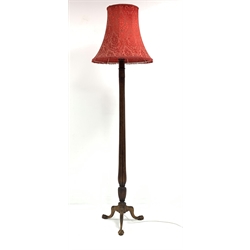 20th century Gillows design standard lamp, with decorative red damask shade raised on water leaf carved and reeded column, with leaf carved triple splay supports terminating in ball and claw feet, H216cm
