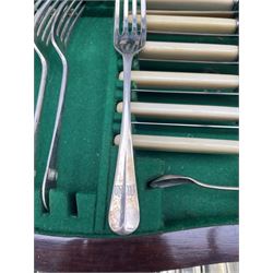 Early 20th century Walker & Hall canteen of silver-plated rat tail cutlery for twelve covers, initialled, lacking eight teaspoons and one egg spoon, in mahogany brass bound case with hinged cover above two drawers, L53cm 