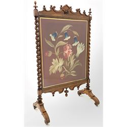 Victorian rosewood fire screen, shaped pediment over needlework glazed panel, spiral turned columns, raised on four scrolled splayed supports H87cm 