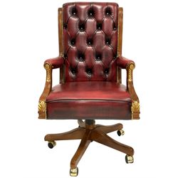 Barnini Oseo - 'Reggenza' swivel office chair, scrolled high back, upholstered in buttoned oxblood leather with gilt studwork, arm terminals decorated with gilt foliate mounts, on castors