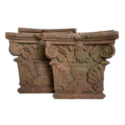 Pair of cast iron square column capitals or collars, four-piece concaved square form decorated with anthemion motifs and central urn 