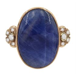 Gold sapphire and diamond ring, the central oval cabochon sapphire with a cluster of round brilliant cut diamonds set either side by Judith Crowe, hallmarked 9ct, sapphire approx 44.30 carat, total diamond weight approx 0.60 carat