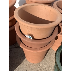 Twelve circular terracotta plant pots (D34cm, H30cm) and two glazed terracotta plant pots