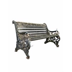 Early 20th century two seat bench, the black and gilt painted ends with leaf and mythical beast decoration, bearing the letters 'M V’ centred by an anchor, possibly standing for ‘motor vessel’ L128cm