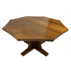 Mouseman - adzed oak octagonal concave dining table, raised on cruciform base, the supports and sledge feet also adzed, carved with fat mouse signature, by the workshop of Robert Thompson, Kilburn
