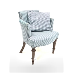 Early 20th century tub shaped armchair, upholstered in blue fabric with lozenge pattern, raised on turned front supports