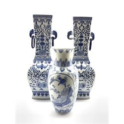  Pair of 20th Century Chinese blue and white vases decorated with flowers and with elephant head handles H46cm and another smaller blue and white vase  