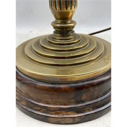 Early 20th century brass lamp, the tapered stem supported by a circular stepped base, raised on lignum vitae turned plinth, H40cm (excluding fitting)