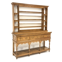 Early 20th century polished pine dresser with associated plat rack, three drawers above potboard base, turned supports, W163cm, H197cm, D43cm
