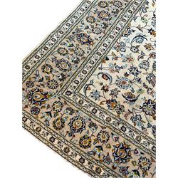 Fine Persian Nain ivory ground carpet, the large central floral pole medallion surrounded by interlacing palmettes with scrolling foliate detail, the multi-band border with repeating stylised plant motifs