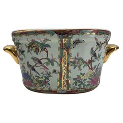 Pair of 20th century Chinese Canton fish bowls, decorated with panels of flowers and foliage on a dense floral ground, the interiors painted with fish, H14cm, together with two Chinese jardinieres (4) Provenance: From the Estate of the late Dowager Lady St Oswald