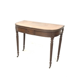 Georgian mahogany fold over tea table, the bow front top with reeded edge, raised on spiral turned supports terminating in brass cup castors, W92cm x 46cm, H76cm