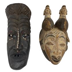 African Tribal 'White Mask', Punu Gabon, whitened with caolin, H34cm and another Tribal mask, of elongated form with shell and bead inlay (2)