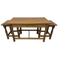 Beaverman - adzed oak nest of three tables, rectangular tops on octagonal turned supports joined by plain stretchers, carved with beaver signature, by Colin Almack, Sutton-under-Whitestone Cliffe