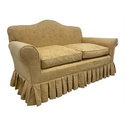 Victorian design two seat humpback sofa, sprung back and seat upholstered in yellow foliate patterned damask fabric, on turned supports united by stretcher
Provenance: From the Estate of the late Dowager Lady St Oswald