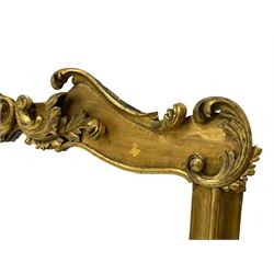 19th century ornate giltwood framed overmantel mirror, the moulded frame mounted by scrolled foliage carvings to the pediment and lower brackets, plain mirror plate