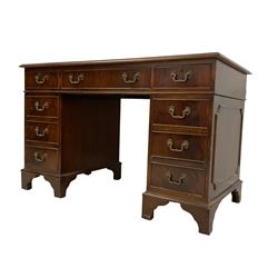 Edwardian mahogany twin pedestal desk, rectangular top with inset leather writing surface and moulded edge, fitted with nine cockbeaded drawers, raised on bracket feet
