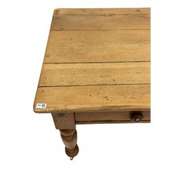 Victorian pine kitchen table, the three planked top over two drawers, raised on turned supports, terminating in brass castors W142cm, D80cm, H77cm