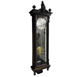 A Gustav Becker (German) late 19th century single weight driven Vienna regulator in a mahogany and ebonised case with a carved decorative pediment and finials, full length arched door and glazed side panels, with a white two piece 7.5” enamel dial, Roman numerals, minute track and subsidiary seconds dial, with pierced steel Viennese hands, dial inscribed “W.T. Braham, Stretford Road