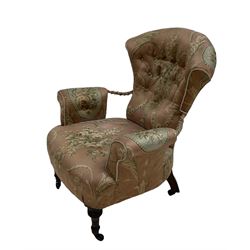 Victorian fan back armchair, upholstered in pink floral fabric, raised on turned supports 