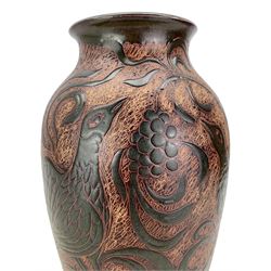 John Egerton (c1945 - ) - Sgraffito vase decorated with grapes, peahens etc in shades of brown and green signed with initials and '96' H36cm