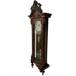 German - late 19th century 8-day walnut and ebony Vienna regulator, pediment with carved decoration and turned pendant finials, fully glazed case door and side panels, two-part enamel dial with roman numerals and seconds dial, single train timepiece movement with weight, pulley and pendulum. With key. 