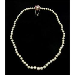 Single strand graduating cultured pearl necklace, with white gold clasp set with rubies, stamped 9ct