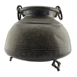 Large 19th century Indian bronze cauldron, the squat form body incised with stylized flowers and calligraphy on foliate ground, two large ring handles and three ring-shaped feet, H47cm x D53cm approx