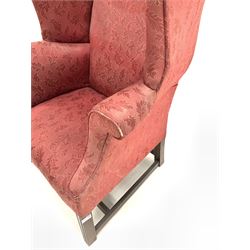 Georgian style high wing back armchair upholstered in claret red floral fabric, raised on moulded square tapered supports W81cm