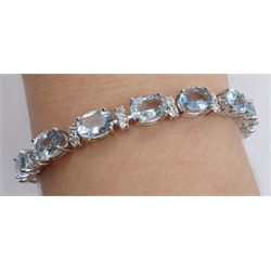 18ct white gold oval aquamarine and diamond bracelet, hallmarked, total aquamarine weight 12.00 carat, total diamond weight approx 1.30 carat